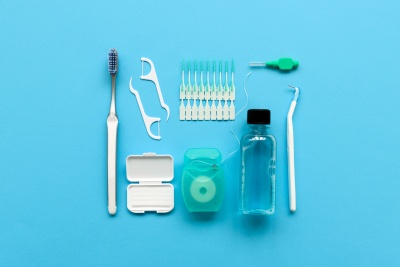 dental hygiene tools neatly arranged on a bright blue background